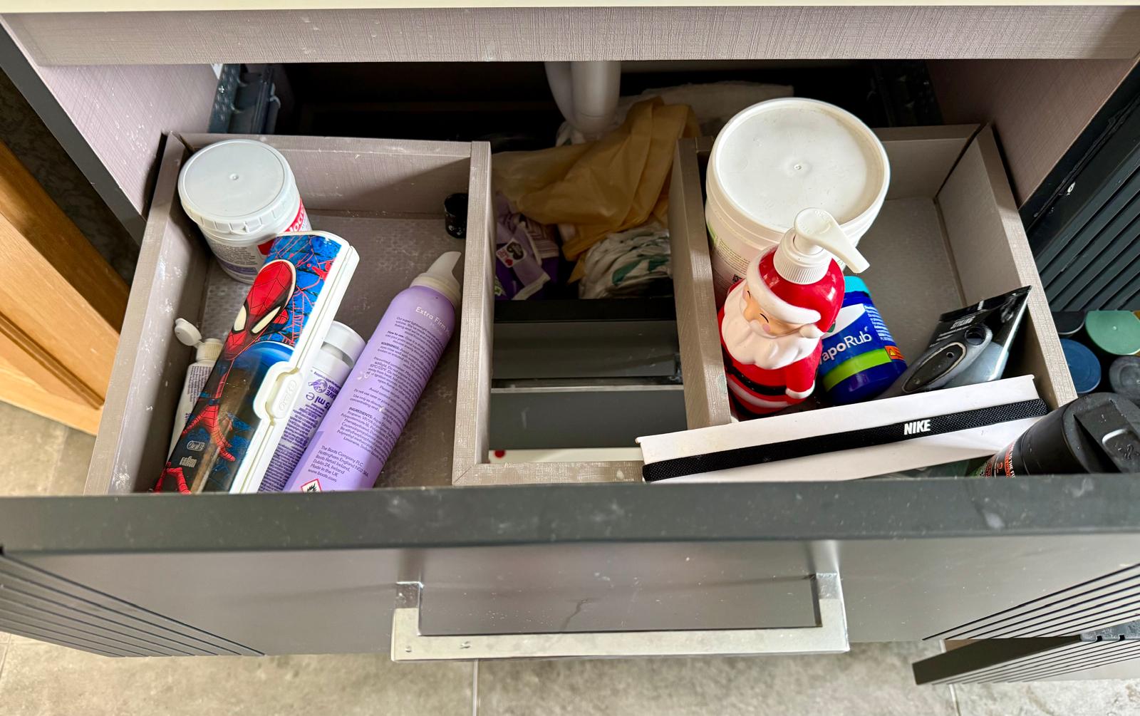 Structured bathroom drawer bins holding lotions, medicines and everyday grooming items