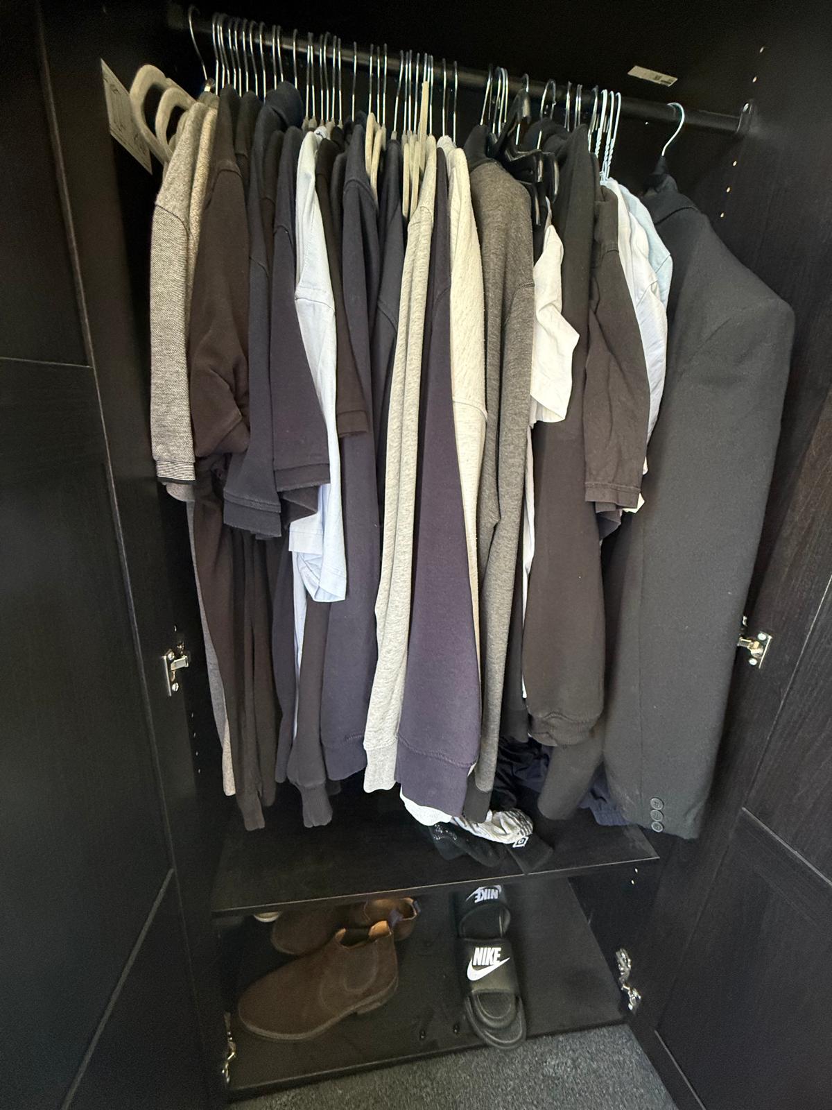 Organised wardrobe rail with matching hangers and clothes sorted by category and colour